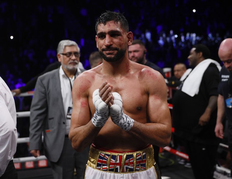 &copy; Reuters. FILE PHOTO: Boxing - Amir Khan v Kell Brook - AO Arena, Manchester, Britain - February 19, 2022 Amir Khan looks dejected after losing the fight Action Images via Reuters/Andrew Couldridge