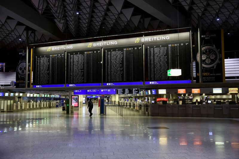 &copy; Reuters. FILE PHOTO: A man walks past a display board showing the list of cancelled flights at Frankfurt airport during a nationwide strike called by the German trade union Verdi over a wage dispute in Frankfurt, Germany, March 27, 2023. REUTERS/Kai Pfaffenbach/Fi