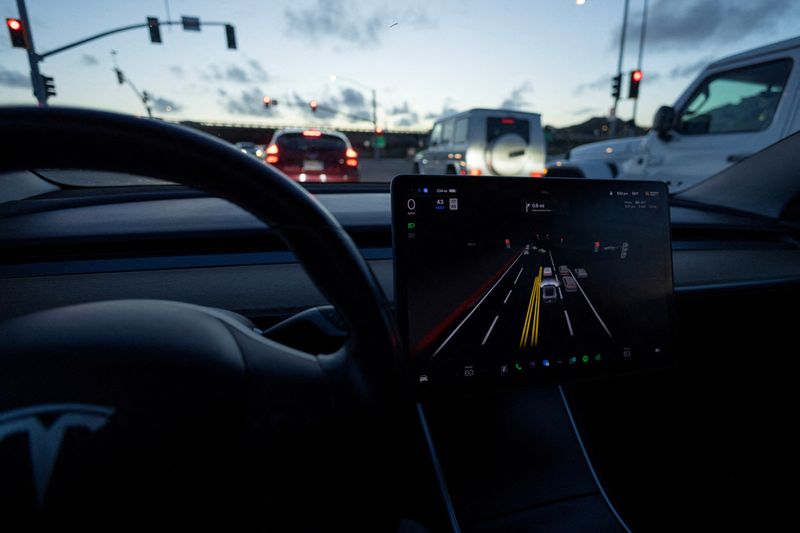 &copy; Reuters. FILE PHOTO: A Tesla Model 3 vehicle is shown using the Autopilot Full Self Driving Beta software (FSD) while navigating a city road in Encinitas, California, U.S., February 28, 2023.  REUTERS/Mike Blake/File Photo