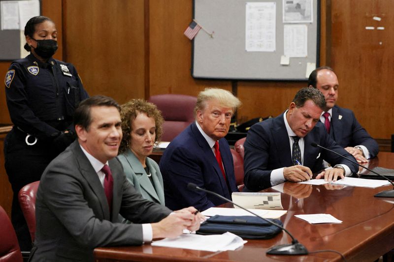 © Reuters. Former U.S. President Donald Trump appears in court with members of his legal team for an arraignment on charges stemming from his indictment by a Manhattan grand jury in New York City, April 4, 2023. REUTERS/Andrew Kelly/Pool    