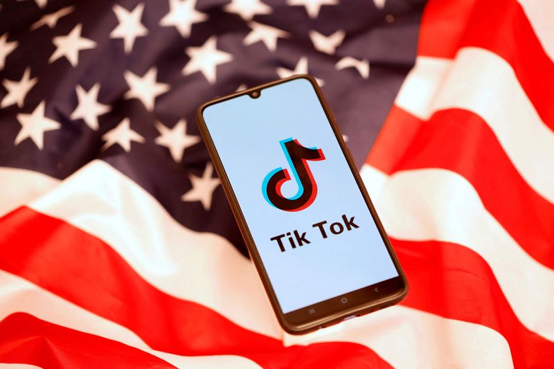 &copy; Reuters. FILE PHOTO: TikTok logo is displayed on the smartphone while standing on the U.S. flag in this illustration picture taken, November 8, 2019. REUTERS/Dado Ruvic