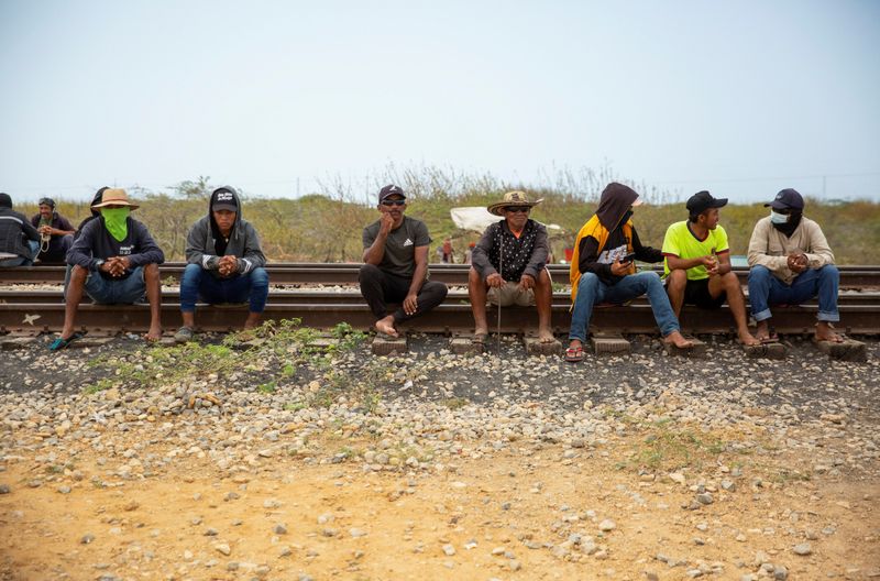 &copy; Reuters. Wayuu indigenous from nearby communities sit on a railway line used by coal producer Cerrejon before lifting a blockade, in Puerto Bolivar, Colombia April 7, 2023.  REUTERS/Antonio Cascio