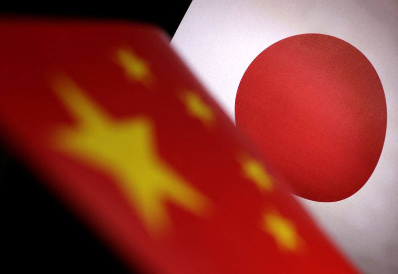&copy; Reuters. Printed Chinese and Japanese flags are seen in this illustration, July 21, 2022. REUTERS/Dado Ruvic/Illustration