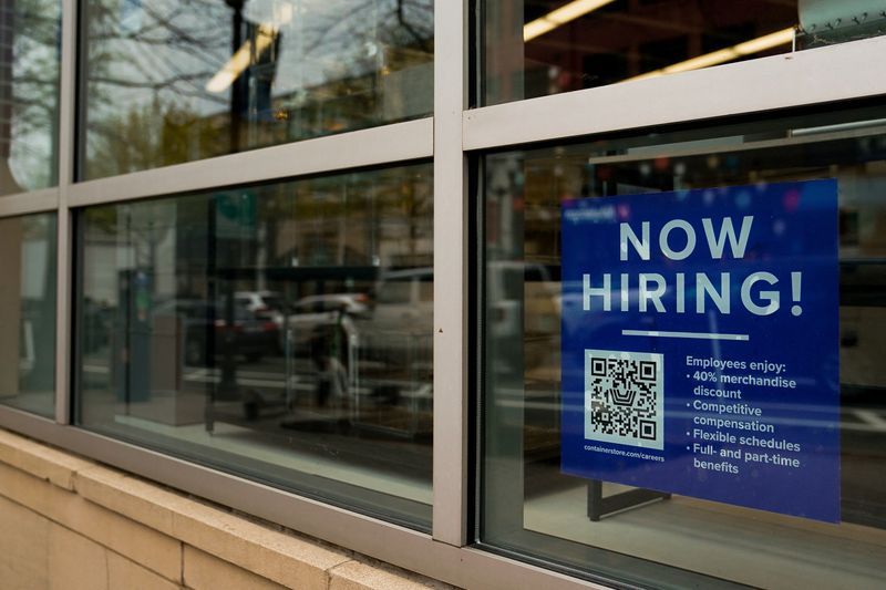 &copy; Reuters. FILE PHOTO: An employee hiring sign with a QR code is seen in a window of a business in Arlington, Virginia, U.S., April 7, 2023. REUTERS/Elizabeth Frantz