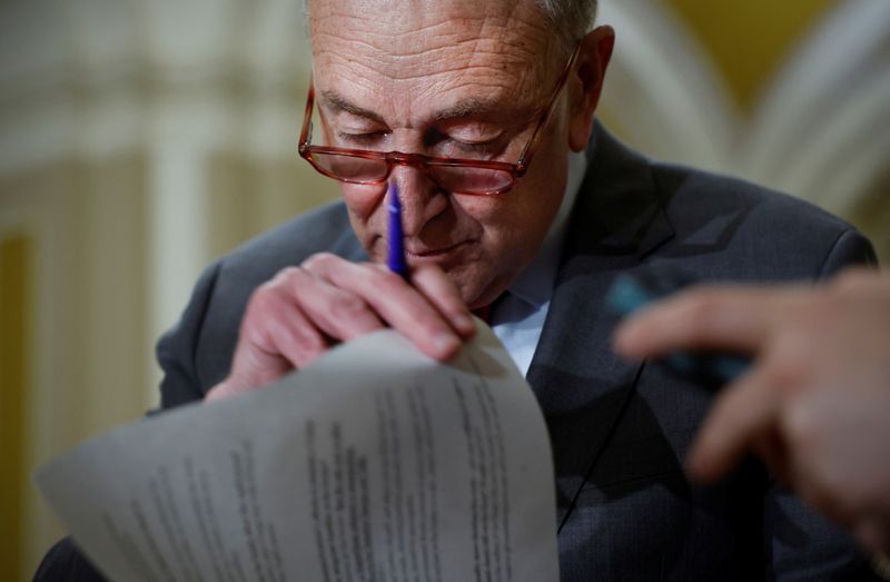 © Reuters. U.S. Senate Majority Leader Chuck Schumer (D-NY) looks at his notes before he speaks to reporters after the weekly Democratic party caucus luncheon at the U.S. Capitol in Washington, March 28, 2023. REUTERS/Evelyn Hockstein