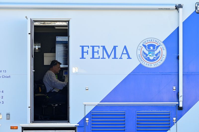 © Reuters. FILE PHOTO: A person sits at a desk inside of a mobile FEMA command center in downtown Dawson Springs, Kentucky, U.S., December 14, 2021. REUTERS/Jon Cherry