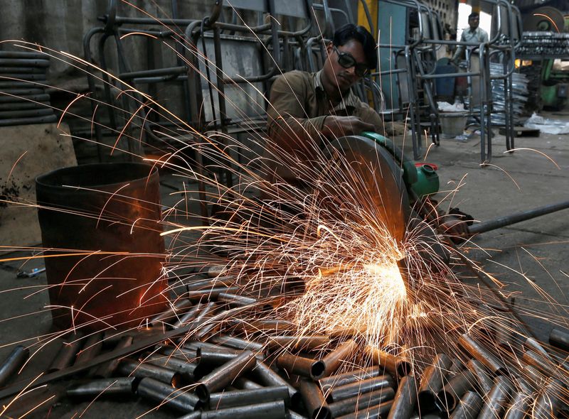 &copy; Reuters. FILE PHOTO: A worker cuts a metal pipe inside a steel furniture production factory in the western Indian city of Ahmedabad February 2, 2015. REUTERS/Amit Dave 