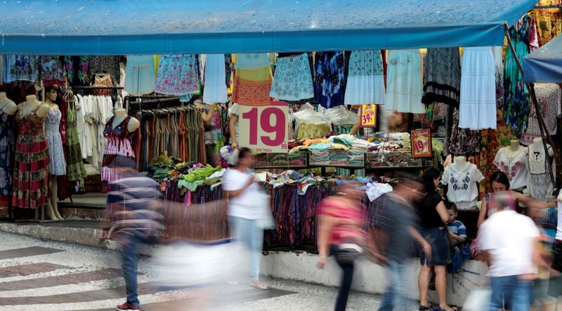 &copy; Reuters. FILE PHOTO: People walk in front of a store on a commercial street in downtown Sao Paulo December 4, 2014.  REUTERS/Paulo Whitaker/File Photo