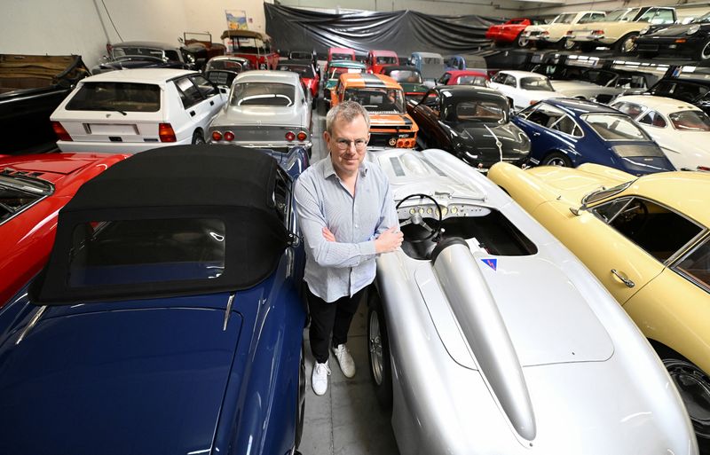 © Reuters. Florian Zimmermann, owner of a collection of more than 300 classic cars poses with cars in Lindau, Germany, April 5, 2023. REUTERS/Angelika Warmuth