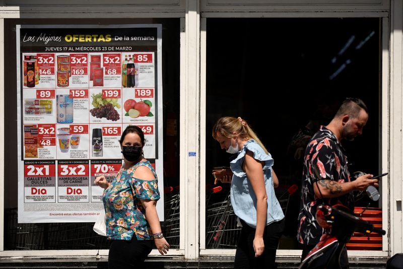 &copy; Reuters. FILE PHOTO: People walk in front of a supermarket as Argentina's Senate is set to debate a debt deal with the International Monetary Fund (IMF) amid soaring inflation, in Buenos Aires, Argentina March 17, 2022. REUTERS/Mariana Nedelcu