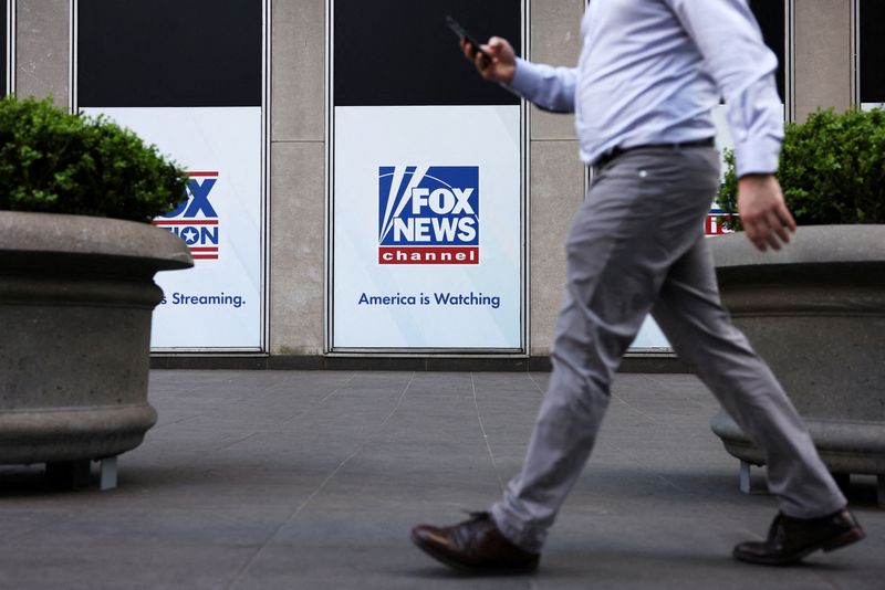 &copy; Reuters. FILE PHOTO: A person walks by Fox News signage posted on the News Corporation building in New York City, U.S. April 12, 2023 REUTERS/Andrew Kelly