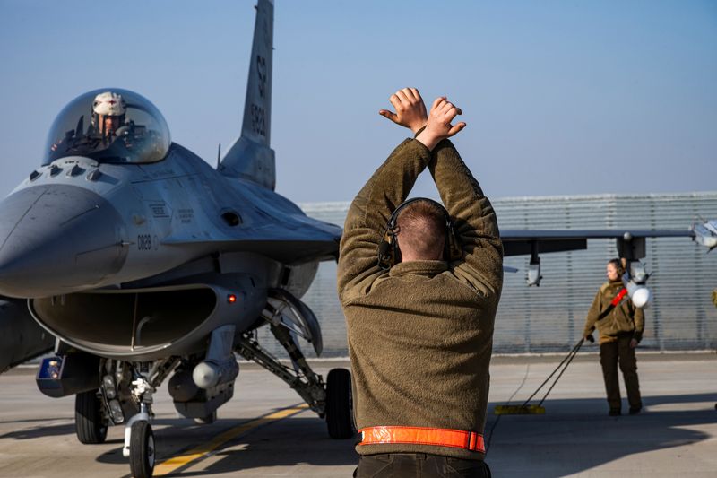 &copy; Reuters. FILE PHOTO: A U.S. Air Force airman marshals an F-16 Fighting Falcon aircraft assigned to the 480th Fighter Squadron, at the 86th Air Base near Fetesti, Romania, February 17, 2022. Picture taken February 17, 2022.  U.S. Air Force/Senior Airman Ali Stewart