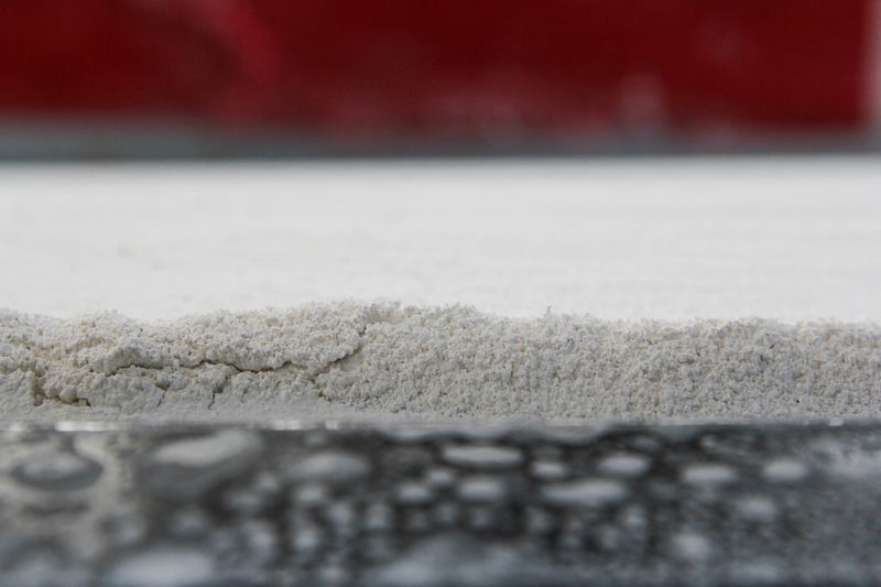 &copy; Reuters. FILE PHOTO: Small particles of a material derived from limestone are seen on a tray for capturing carbon at the Heirloom Carbon Technologies facility in Brisbane, California, U.S. February 1, 2023. REUTERS/Nathan Frandino/File Photo