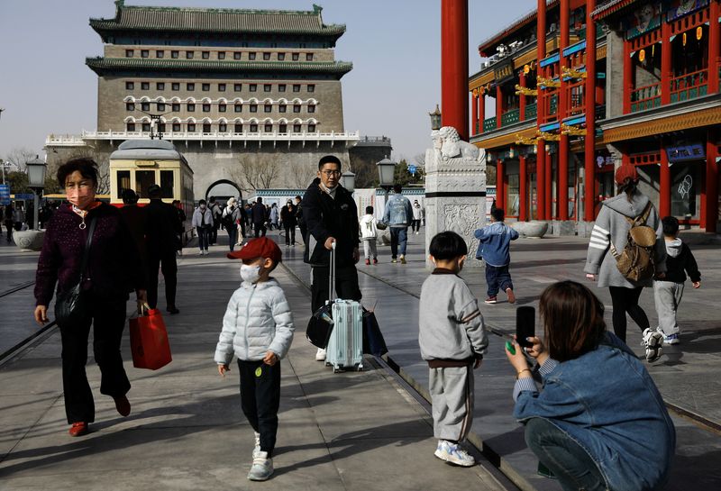 &copy; Reuters. FILE PHOTO: People walk at a tourism site in Qianmen street, Beijing, China March 14, 2023. REUTERS/Tingshu Wang/File Photo