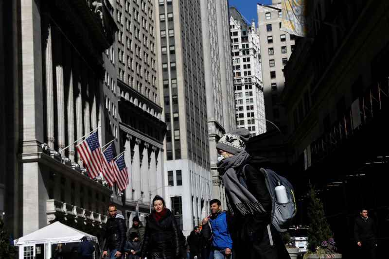 &copy; Reuters. FILE PHOTO: A woman wears a mask near the New York Stock Exchange (NYSE) in the Financial District in New York, U.S., March 4, 2020. REUTERS/Brendan McDermid