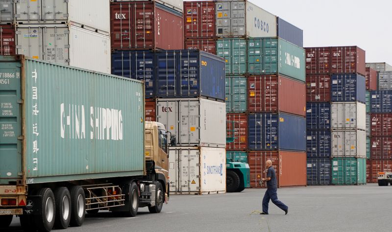 &copy; Reuters. FILE PHOTO: A laborer works in a container area at a port in Tokyo, Japan July 19, 2017. Picture taken July 19, 2017. REUTERS/Toru Hanai