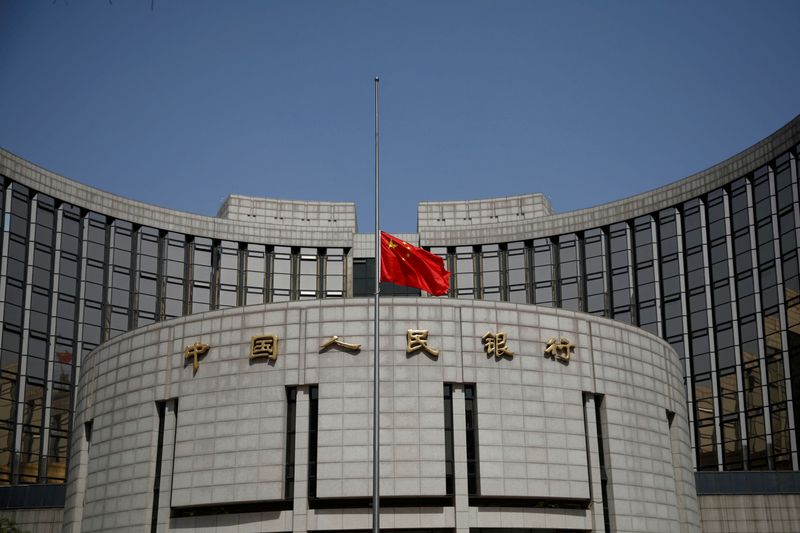 &copy; Reuters. FILE PHOTO: The Chinese national flag flies at half-mast at the headquarters of the People's Bank of China, the central bank (PBOC), as China holds a national mourning for those who died of the coronavirus disease (COVID-19), on the Qingming tomb-sweeping