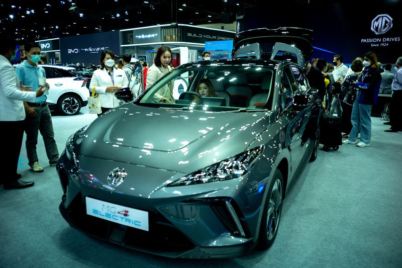 &copy; Reuters. FILE PHOTO: People are seen next to the MG 4 EV car at the 39 Thailand International Motor Expo, in Bangkok, Thailand, November 30, 2022. REUTERS/Athit Perawongmetha