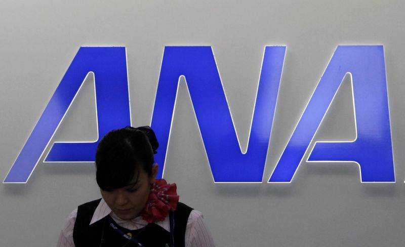 &copy; Reuters. FILE PHOTO: An employee of All Nippon Airways (ANA) works in front of the company logo at New Chitose airport in Chitose, northern Japan July 3, 2012. All Nippon Airways Co said on Tuesday it is raising up to $2.6 billion through the issue of as many as o