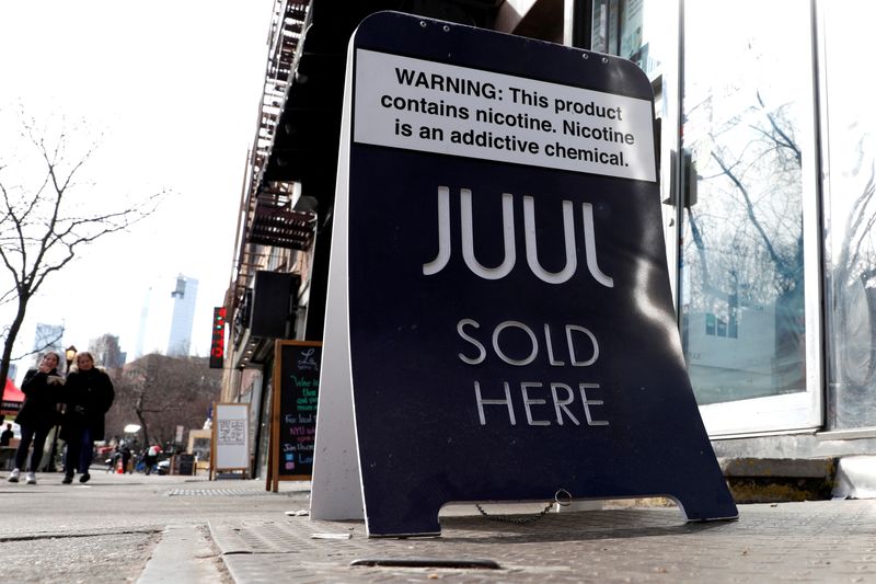 &copy; Reuters. FILE PHOTO: A sign advertising Juul brand vaping products is seen outside a shop in Manhattan in New York City, New York, U.S., February 6, 2019. REUTERS/Mike Segar/File Photo