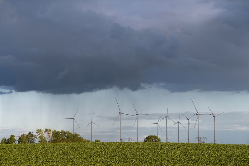&copy; Reuters. FILE PHOTO: Rain clouds are pictured over power-generating wind turbines near Prenzlau, Germany June 13, 2022. REUTERS/Annegret Hilse