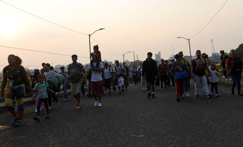 &copy; Reuters. Migrants take part in a caravan towards Mexico City called 'The Migrant's Via Crucis' in memory of the 40 migrants who died during a fire at a migrant detention center in the border city of Ciudad Juarez, as they walk along the road en route to Viva Mexic