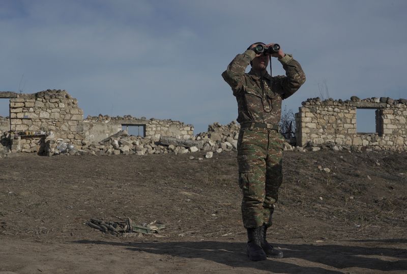 &copy; Reuters. Un soldat d'origine arménienne se tient à des positions de combat près du village divisé de Taghavard dans la région du Haut-Karabakh. /Photo prise le 11 janvier 2021/REUTERS/Artem Mikryukov
