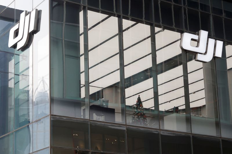 &copy; Reuters. FILE PHOTO: Logos of Chinese drone maker DJI are seen on the facade of its store in Beijing, China December 15, 2021. REUTERS/Carlos Garcia Rawlins