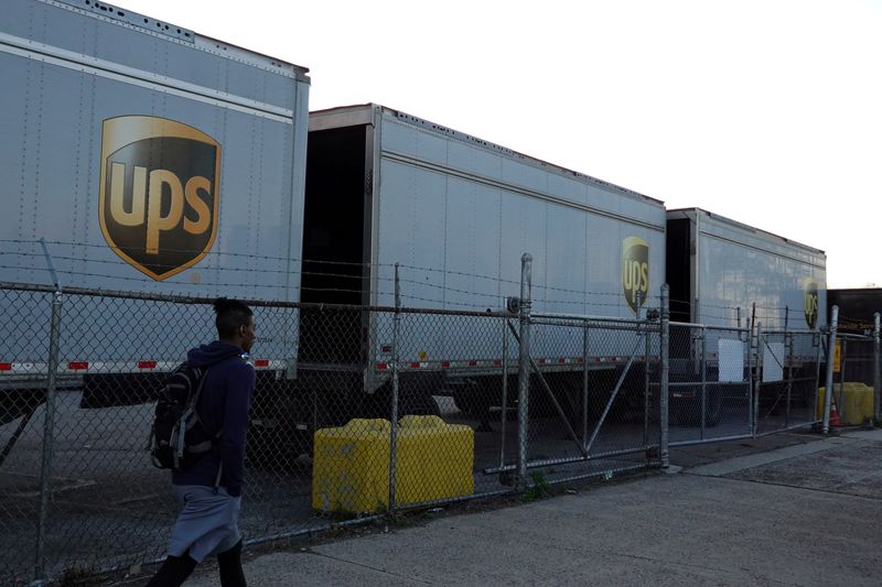 &copy; Reuters. FILE PHOTO: A person walks by United Parcel Service (UPS) trailers at a facility in Brooklyn, New York City, U.S., May 9, 2022. REUTERS/Andrew Kelly
