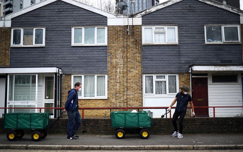 &copy; Reuters. FILE PHOTO: Volunteers cart food donations from a local food bank through the Carpenters Estate in Stratford, as the spread of the coronavirus disease (COVID-19) continues, in east London, Britain, March 31, 2020. REUTERS/Hannah McKay