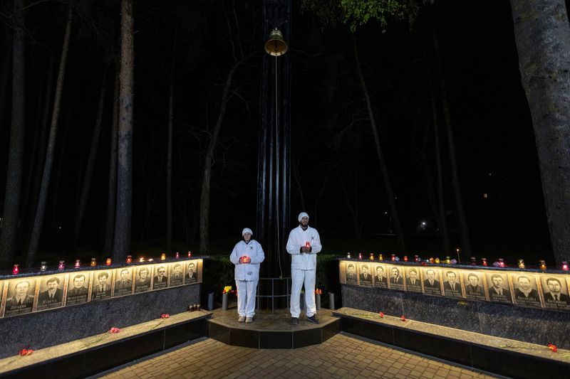 © Reuters. Staff of the Chornobyl nuclear plant hold candles at a memorial dedicated to firefighters and workers who died after the Chornobyl nuclear disaster, during a night commemorative service, amid Russia’s attack on Ukraine, in Slavutych, Ukraine April 26, 2023. REUTERS/Valentyn Ogirenko