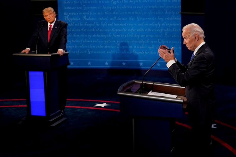 © Reuters. FILE PHOTO: Democratic presidential candidate former Vice President Joe Biden answers a question as President Donald Trump listens during the second and final presidential debate at the Curb Event Center at Belmont University in Nashville, Tennessee, U.S., October 22, 2020. Morry Gash/Pool via REUTERS