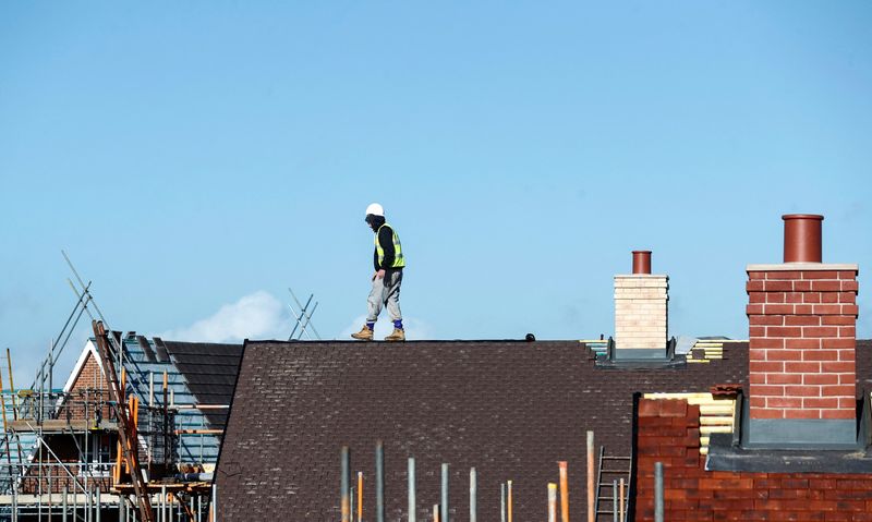 &copy; Reuters. FILE PHOTO: A construction worker walks on a roof as works on a Taylor Wimpey housing estate in Aylesbury, Britain, February 7, 2017. REUTERS/Eddie Keogh/File Photo