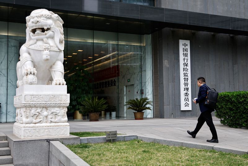 &copy; Reuters. FILE PHOTO: A man enters the China Banking and Insurance Regulatory Commission (CBIRC) building in Beijing, China April 20, 2023. REUTERS/Tingshu Wang