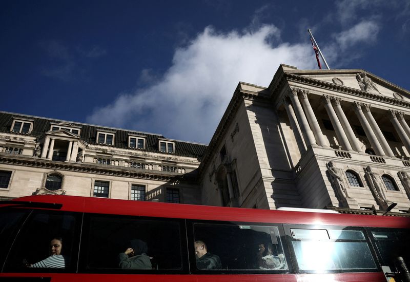 &copy; Reuters. FILE PHOTO: People sit onboard a public bus outside the Bank of England in the City of London financial district in London, Britain, March 23, 2023. REUTERS/Henry Nicholls/File Photo