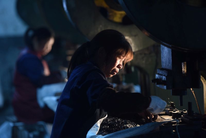 &copy; Reuters. FILE PHOTO: Employees work on a production line manufacturing metal parts for furniture at a factory in Hangzhou, Zhejiang province, China April 30, 2020. China Daily via REUTERS