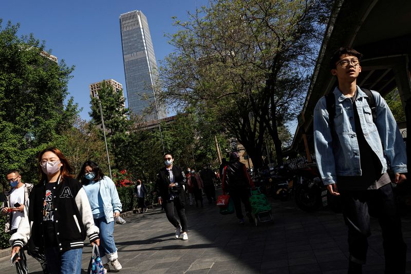 &copy; Reuters. FILE PHOTO: People walk on a street at the Beijing's Central Business District (CBD) during morning rush hour, in Beijing, China April 18, 2023. REUTERS/Tingshu Wang