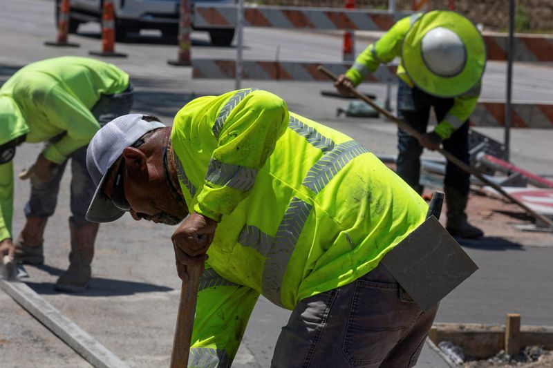 &copy; Reuters. FILE PHOTO: Construction workers work on a road in Dallas, Texas, U.S. July 12, 2022.  REUTERS/Shelby Tauber/File Photo