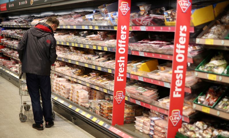 &copy; Reuters. FILE PHOTO: A shopper walks along the meat aisle inside an ALDI supermarket near Altrincham, Britain, February 20, 2023. REUTERS/Phil Noble