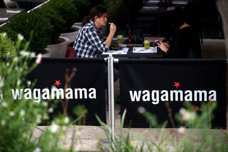 © Reuters. FILE PHOTO: People sit in a Wagamama restaurant in London, Britain, October 5, 2020. REUTERS/Hannah McKay