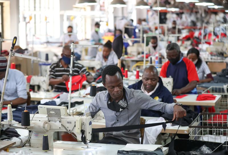 &copy; Reuters. FILE PHOTO: People work at ''The Faktory", a fashion design and clothing manufacturing company in Johannesburg, South Africa, March 4, 2021. REUTERS/Siphiwe Sibeko