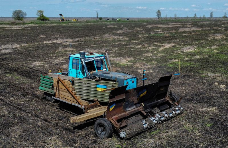 &copy; Reuters. A remote controlled demining machine, created by local farmer Oleksandr Kryvtsov with his tractor and armoured plates from destroyed Russian military vehicles, is seen during demining of an agricultural field, amid Russia's attack on Ukraine, near the vil