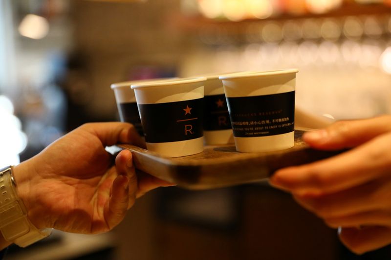 &copy; Reuters. FILE PHOTO: A barista serves coffee at a Starbucks flagship store in Beijing, China January 18, 2022. REUTERS/Tingshu Wang