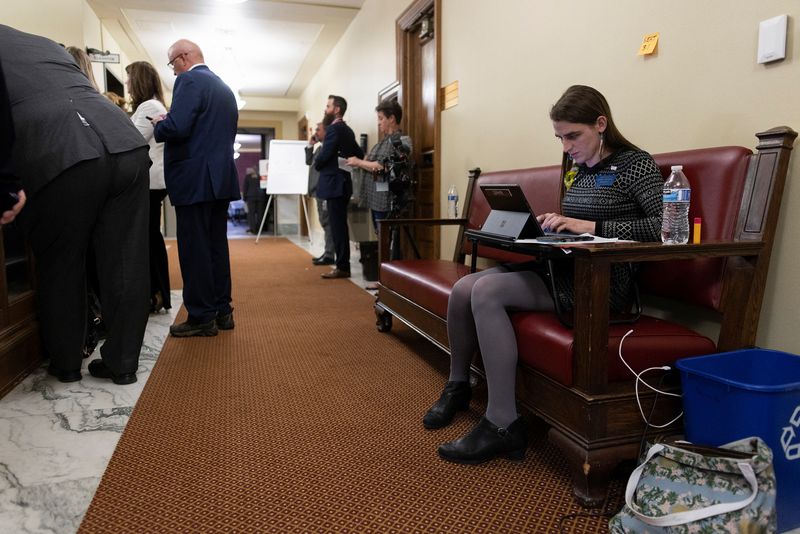 &copy; Reuters. Montana State Representative Zooey Zephyr, who was barred from accessing the House chamber, works remotely from a bench outside of the House chamber at the Montana State Capitol in Helena, Montana, U.S. May 2, 2023. REUTERS/Mike Clark NO RESALES. NO ARCHI