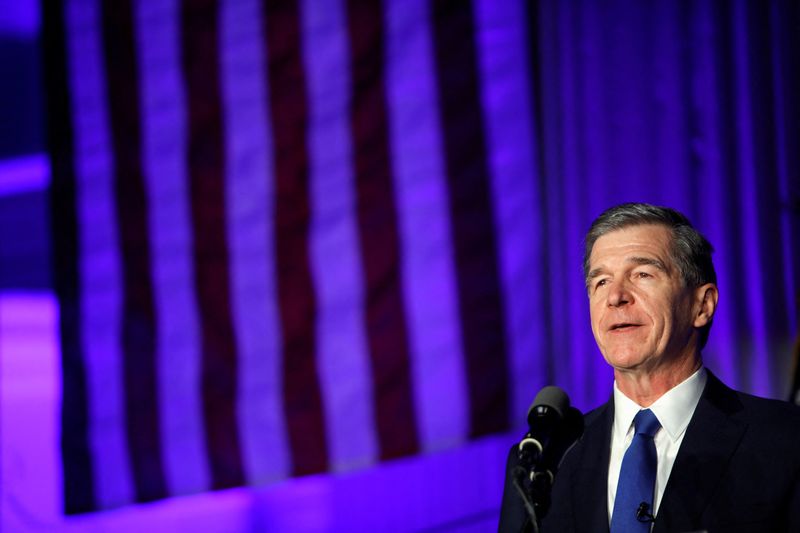 &copy; Reuters. FILE PHOTO: North Carolina Governor Roy Cooper gives his victory speech next to wife Kristin Cooper (not pictured) following his successful reelection bid in Raleigh, North Carolina, U.S., November 3, 2020. REUTERS/Jonathan Drake