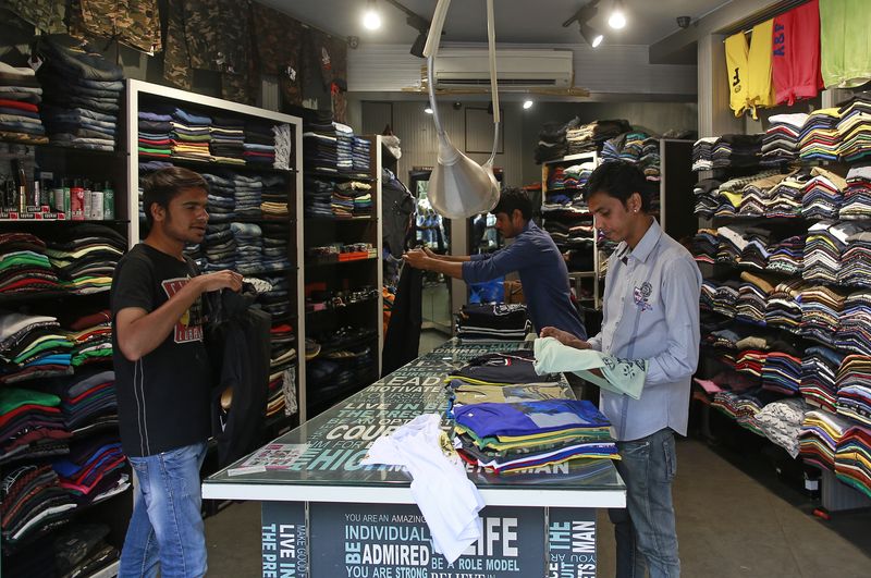 &copy; Reuters. FILE PHOTO: Salesmen fold shirts inside a clothes store at a market in Mumbai, India, March 3, 2016. REUTERS/Danish Siddiqui