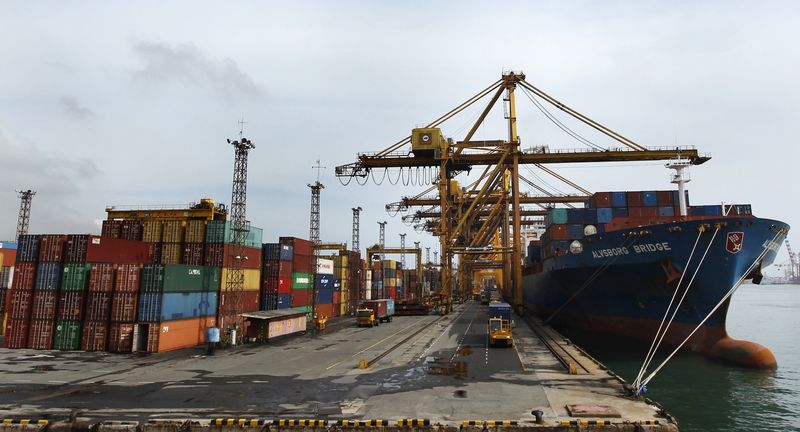 &copy; Reuters. FILE PHOTO: Containers and a ship are seen at Colombo Port July 24, 2013. REUTERS/Dinuka Liyanawatte