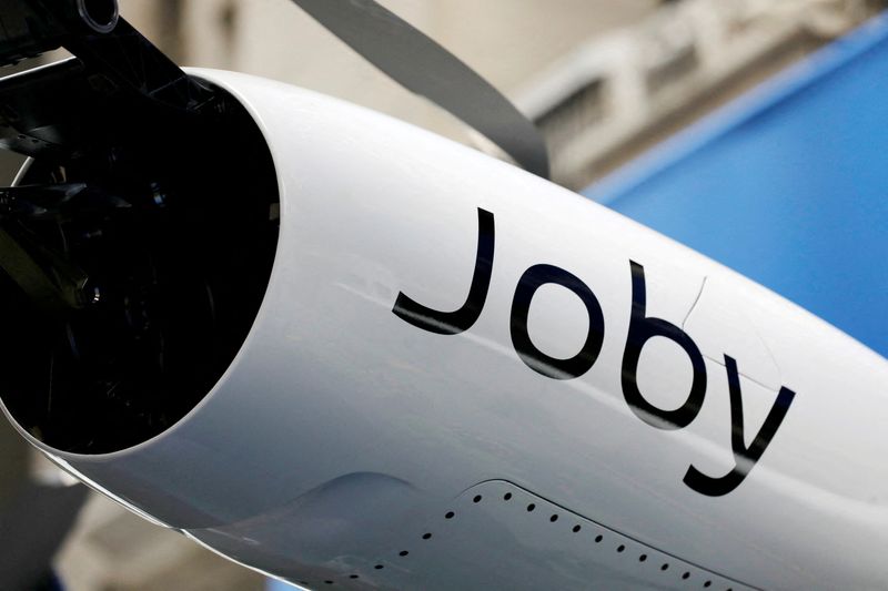 &copy; Reuters. Signage is seen on the Joby Aviation Air Taxi outside the New York Stock Exchange (NYSE) in Manhattan, New York City, U.S., August 11, 2021. REUTERS/Andrew Kelly/File Photo
