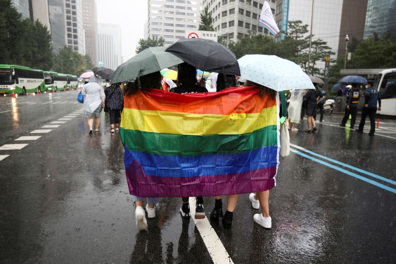 &copy; Reuters. FILE PHOTO: Participants wave a rainbow flag as they march on a street during the Korea Queer Culture Festival 2022 in central Seoul, South Korea, July 16, 2022.  REUTERS/ Heo Ran/File Photo