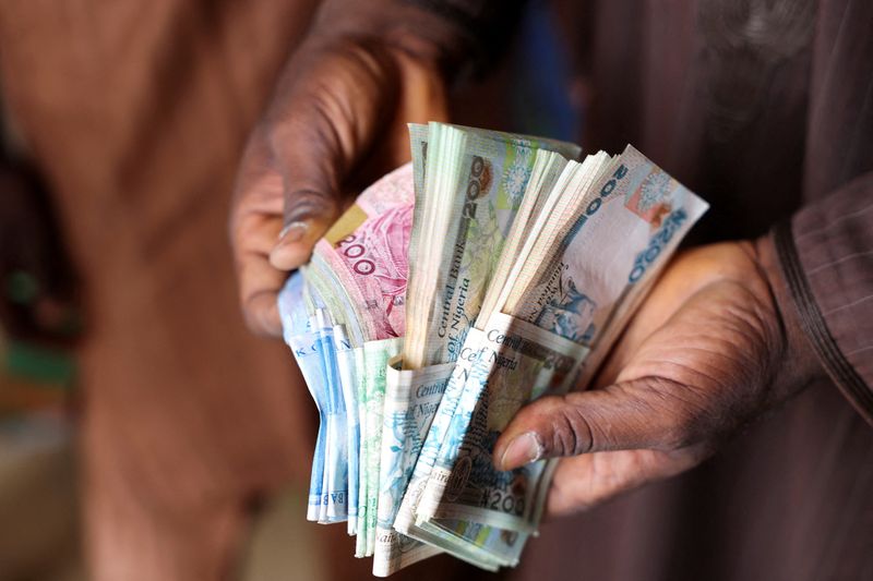 &copy; Reuters. FILE PHOTO: A man counts Nigerian naira notes in a market place as people struggle with the economic hardship and cashflow problems ahead of Nigeria's Presidential elections, in Yola, Nigeria, February 22, 2023. REUTERS/Esa Alexander